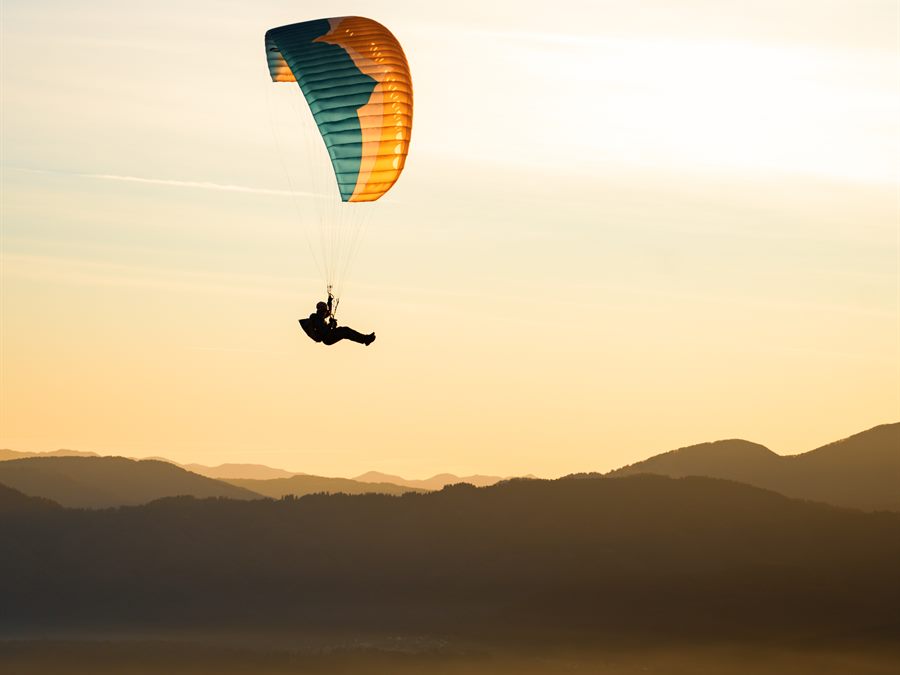 Paraglider above a sea of cloud