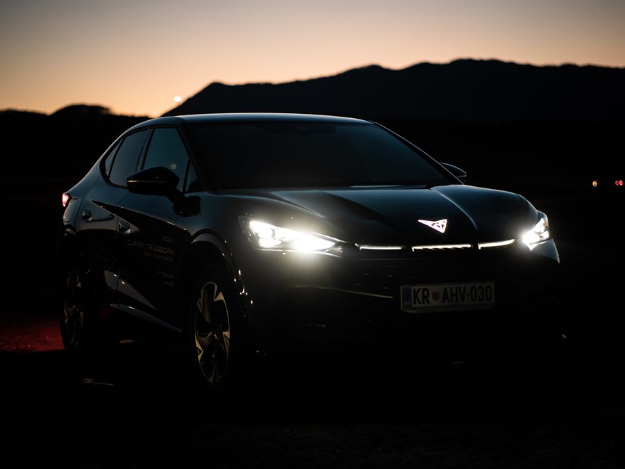 Car with its lights on at dusk