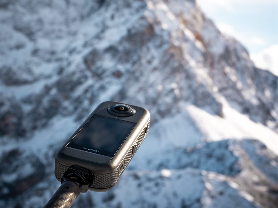 Action camera against snow-covered peaks