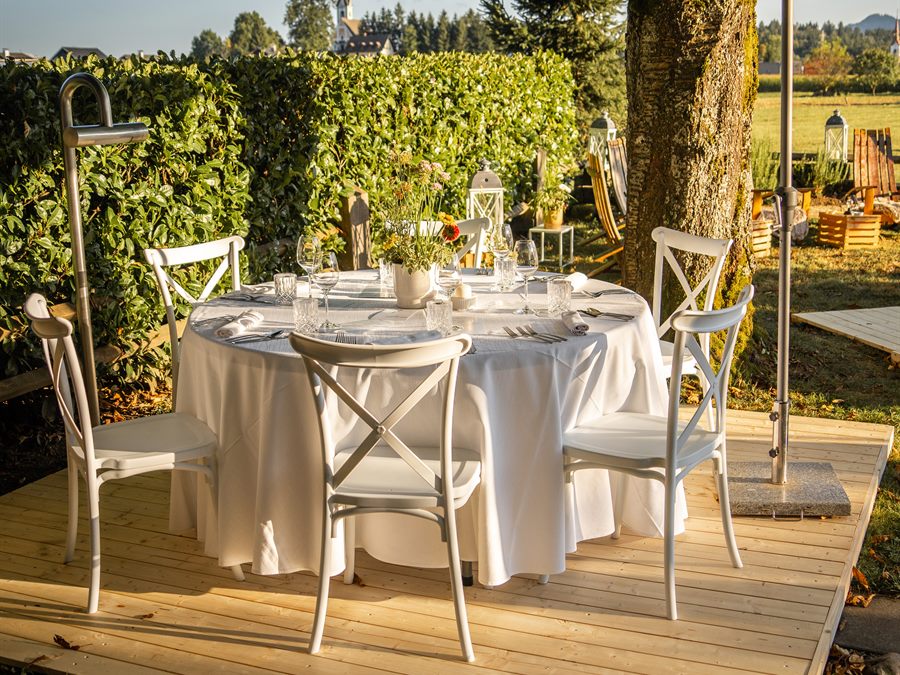 A laid table on a wooden terrace