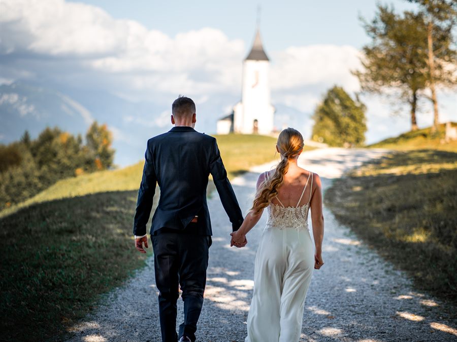 Bride and groom walking up to the church