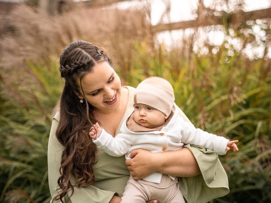 A mother with her baby in the long grass