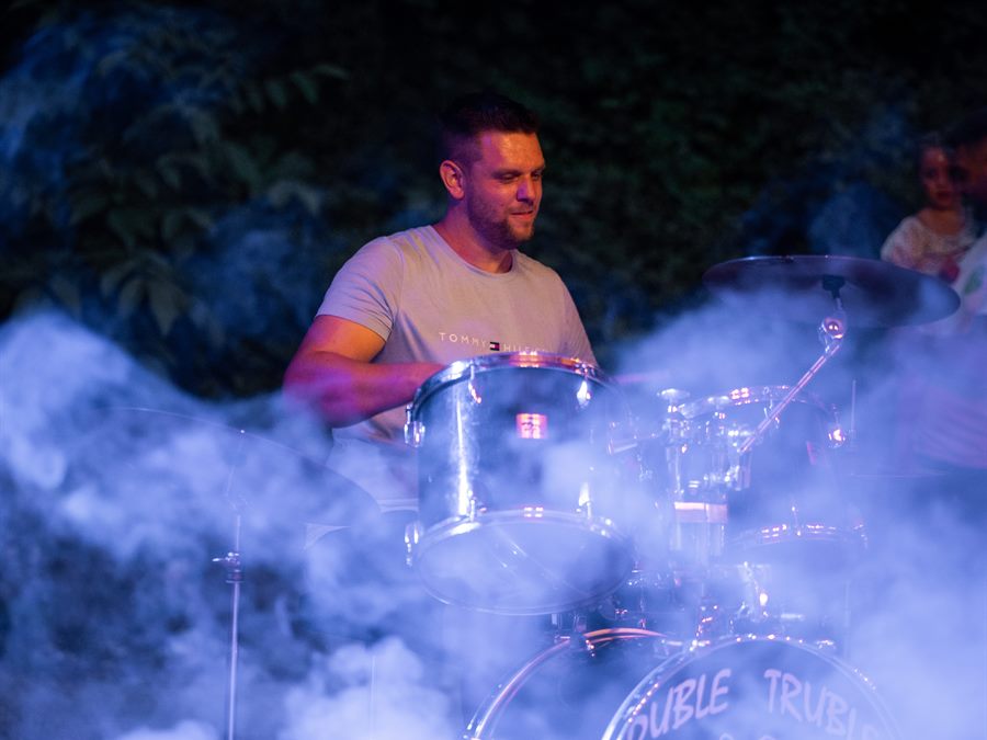 A drummer on stage in the smoke