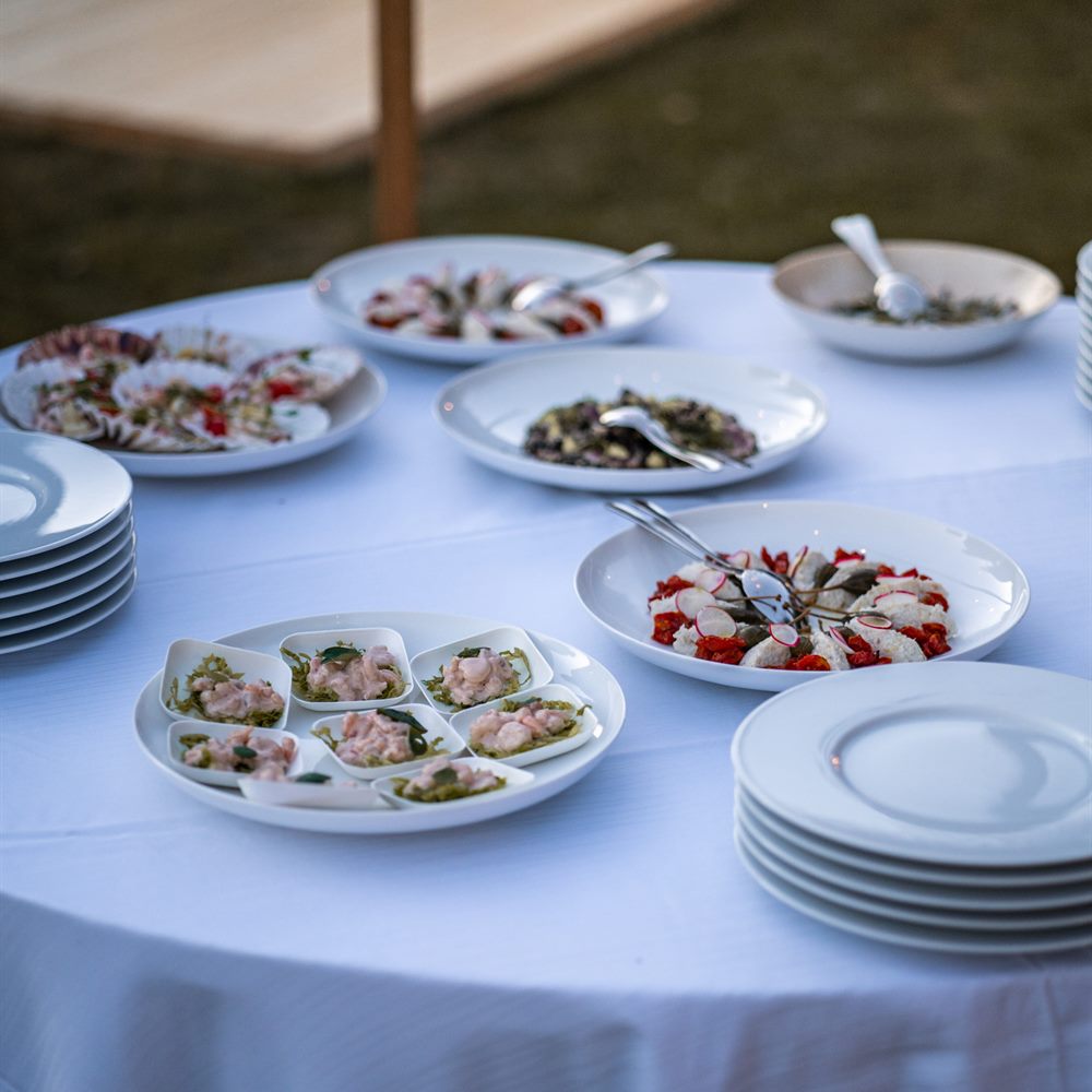 Plates of canapés on a laid table